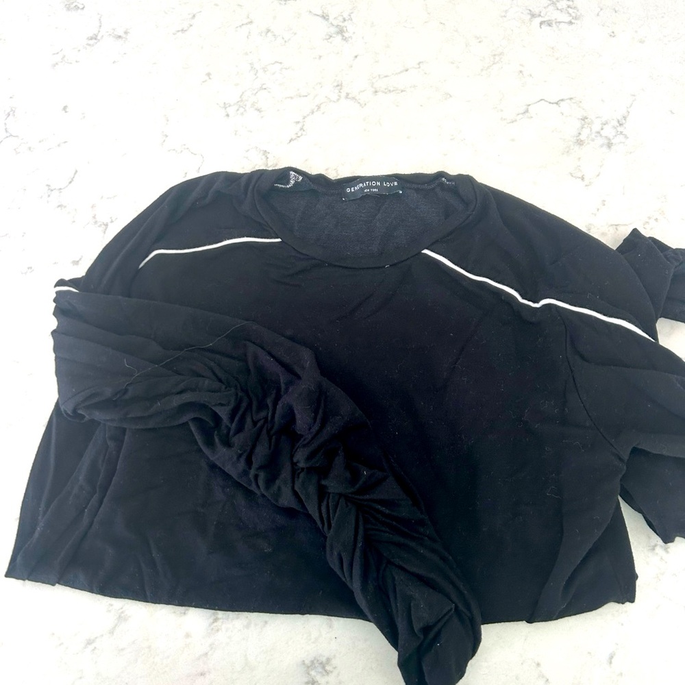 Generation love black sweatshirt with pinched sleeve and white piping.